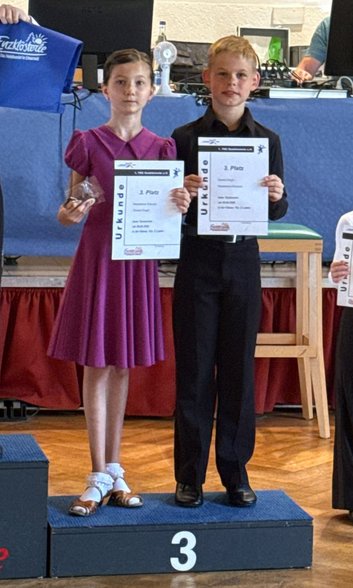 Madeleine und Daniel auf dem Siegerpodest mit der Urkunde für den 3. Platz